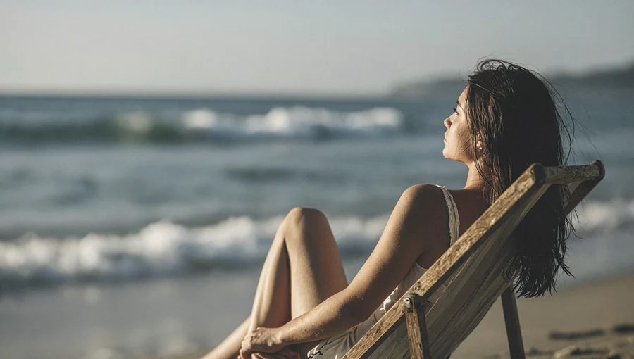 Woman On Weathered Beach Chair At Sunset