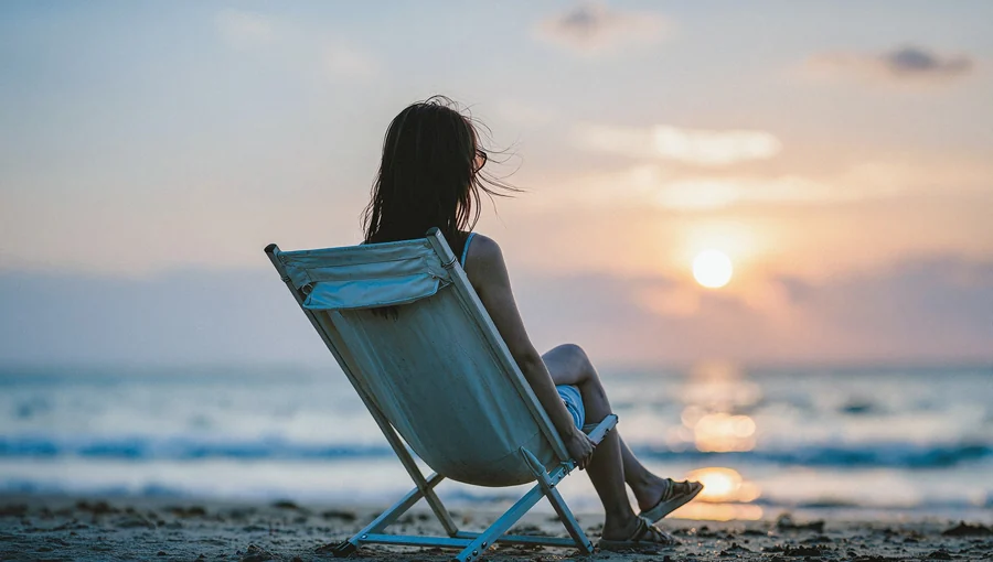 Solitary Woman In Beach Chair At Sunset